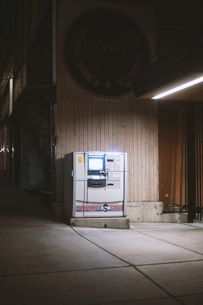 a white machine sitting on the side of a building